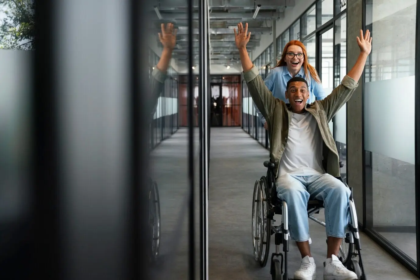 A disabled man using a wheelchair as he works at his office job.