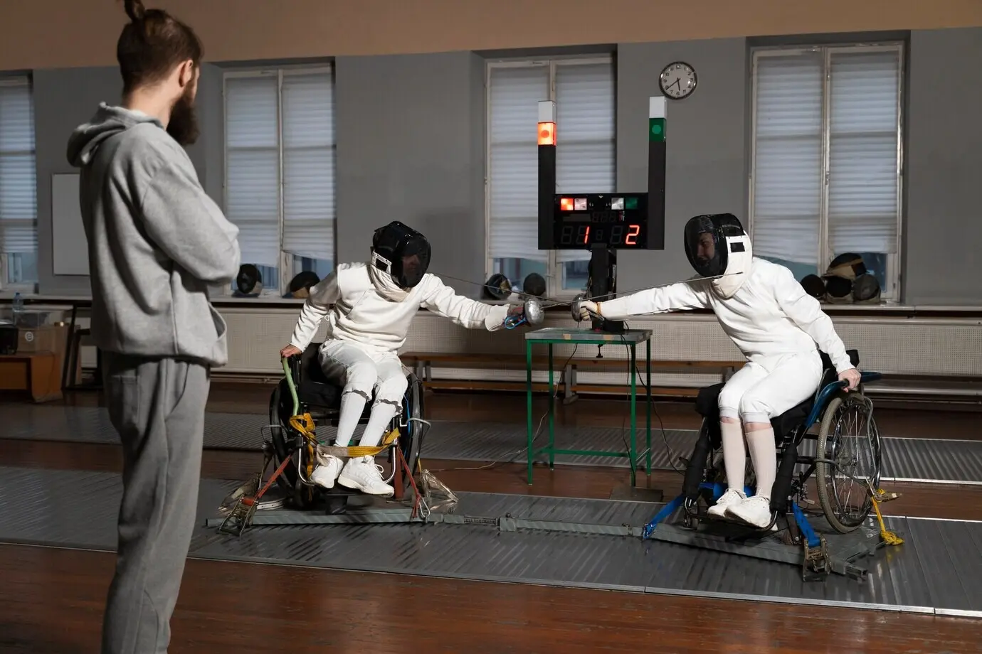 Fencers with disabilities wearing special gear competing in their wheelchairs